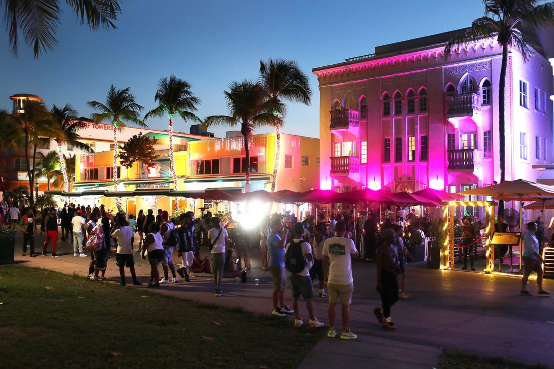 People enjoy themselves as they walk along Ocean Drive on March 18, 2021 in Miami Beach, Florida
