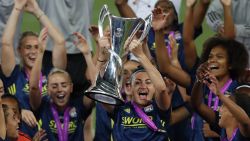 Lyon's English forward Jodie Taylor (C) raises the trophy as Lyon's players celebrate after Lyon won the UEFA Women's Champions League final football match between VfL Wolfsburg and Lyon at the Anoeta stadium in San Sebastian on August 30, 2020. (Photo by Clive Brunskill / POOL / AFP) (Photo by CLIVE BRUNSKILL/POOL/AFP via Getty Images)