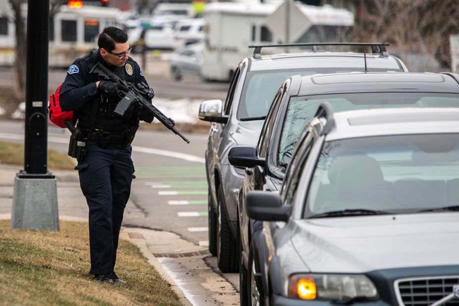 A police officer checks cars in the area.