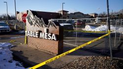Caution tape stretches along a makeshift fence put up around the parking lot outside a King Soopers grocery store where a mass shooting took place a day earlier in Boulder, Colo., Tuesday, March 23, 2021.  (AP Photo/David Zalubowski)