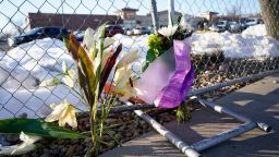 A small memorial stands along a makeshift fence put up around the parking lot outside a King Soopers grocery store where a mass shooting took place a day earlier in Boulder, Colo., Tuesday, March 23, 2021.  (AP Photo/David Zalubowski)