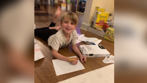 Coomber's son Gus, now in first grade, doing his school work at home.
