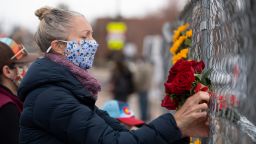 Marh 23, 2021; Boulder, CO, USA; A woman adds flowers to a memorial outside the King Soopers store after the mass shooting where 10 people died in Boulder, Colo. on Tuesday, March 23, 2021. Mandatory Credit: Bethany Baker-USA TODAY NETWORK/Sipa USA 