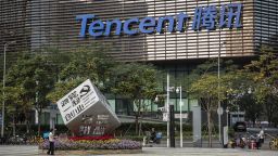 A worker waters the flowers around an installation reading "Follow Our Party Start Your Business" in front of the Tencent Holdings Ltd. headquarters in Shenzhen, China, on Saturday, March 20, 2021. Asias largest conglomerate was?censured?by Chinas antitrust watchdog on Friday as Beijing expands a crackdown that began with Jack Mas online empire. Photographer: Qilai Shen/Bloomberg via Getty Images