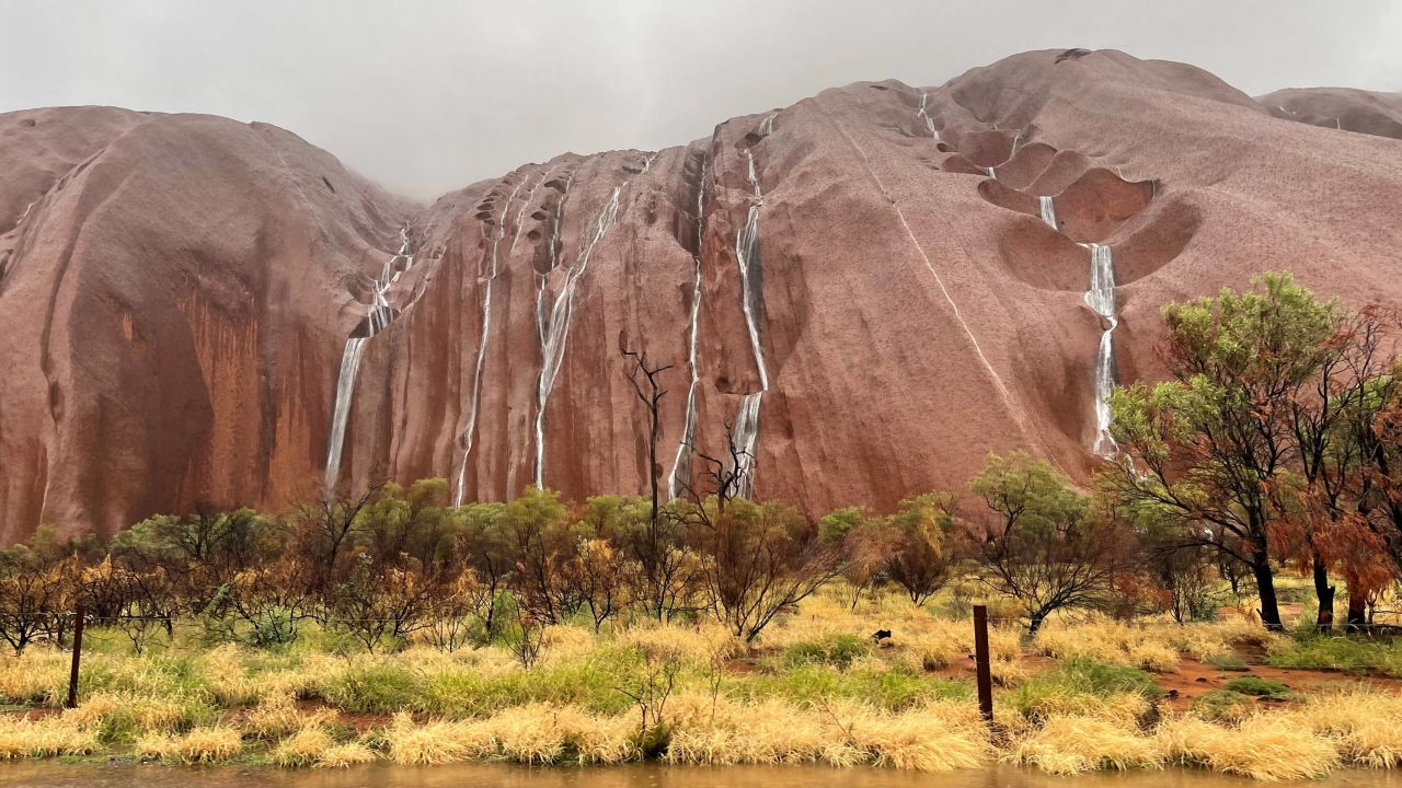 Waterfalls tumble over the surface of Uluru in the Northern Territory, Australia, on March 21
