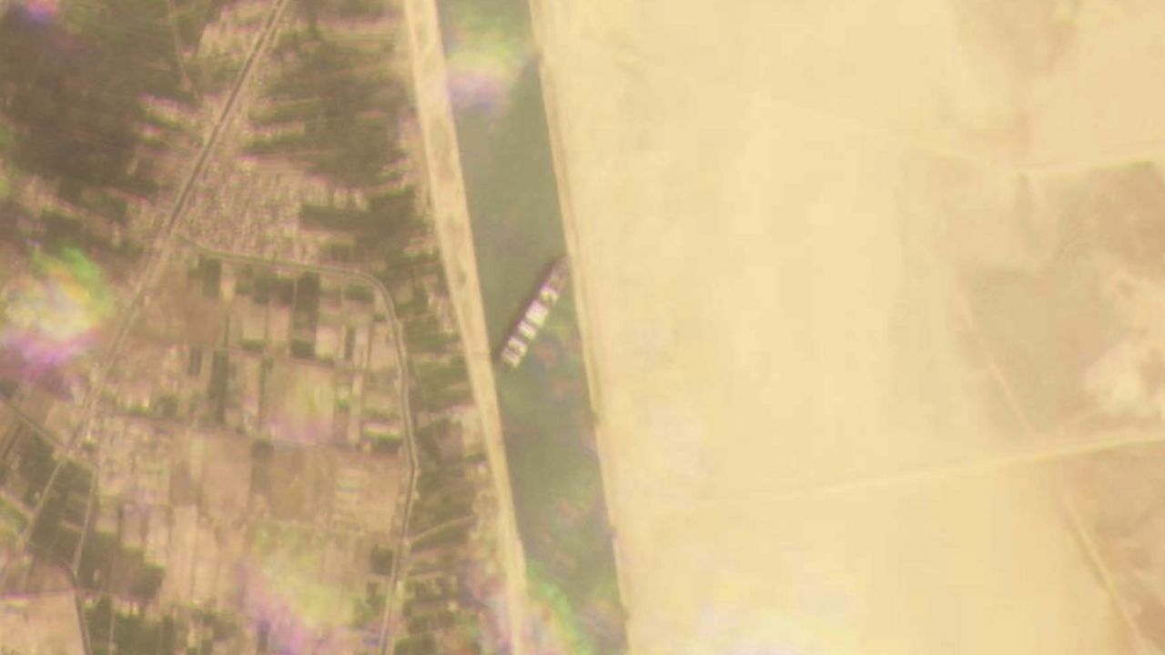 This satellite image from Planet Labs Inc. shows the cargo ship lodged across the waterway.