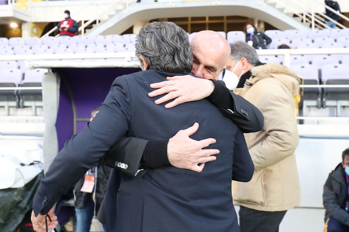 AC Milan coach Stefano Pioli hugs Cesare Prandelli before Sunday's clash, Prandelli's last in charge of Fiorentina.
