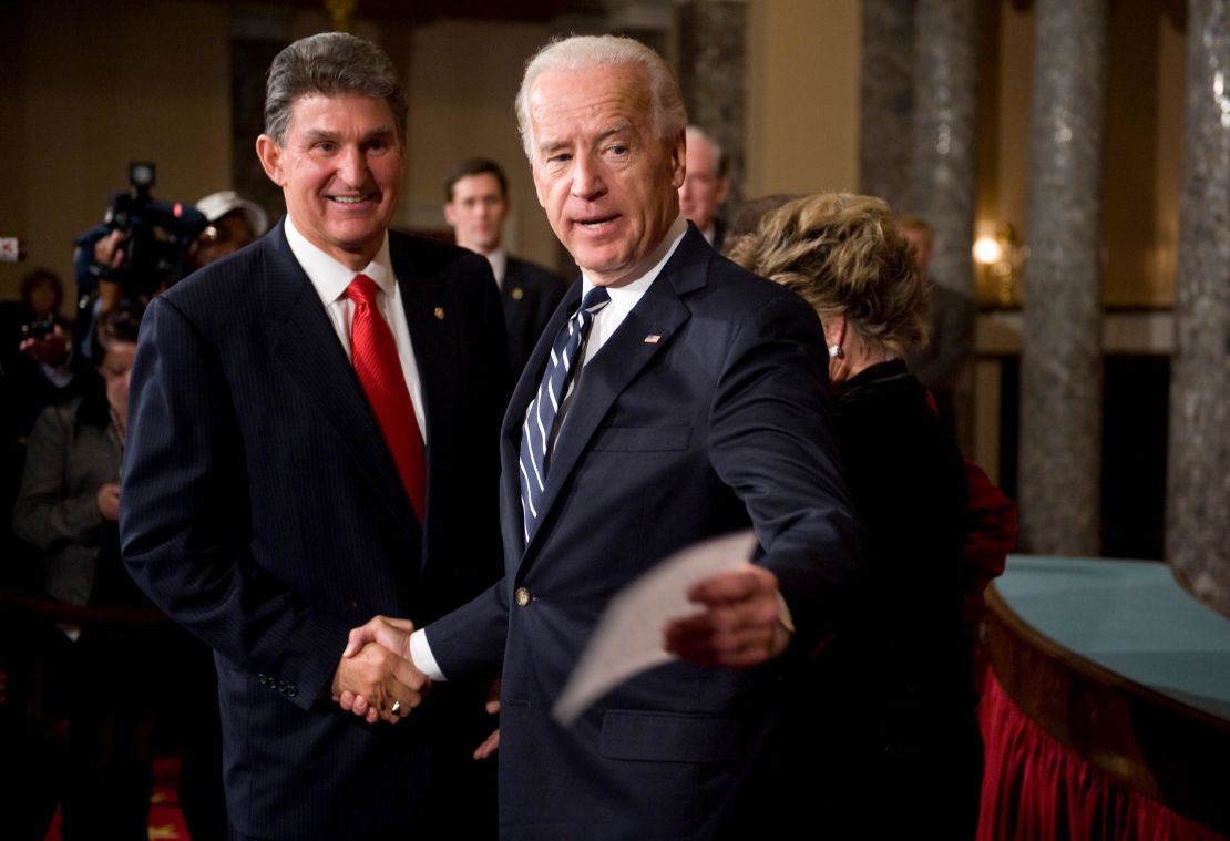 Sen. Joe Manchin, D-W.V., talks with then Vice President Joe Biden who conducted a mock swearing in ceremony in the Old Senate Chamber.