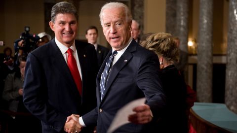 Sen. Joe Manchin, D-W.V., talks with then Vice President Joe Biden who conducted a mock swearing in ceremony in the Old Senate Chamber.