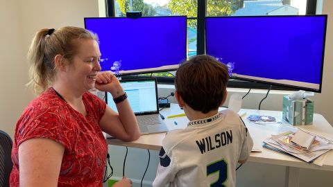 Wenzel takes a break to laugh with her son while working from home in Manhattan Beach, California, where she and her family moved during the pandemic.