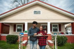 Jomaree Davis and his mother Sharon in front of their new rental home in Ensley, Alabama.