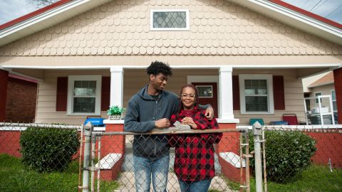 Jomaree Davis and his mother Sharon in front of their new rental home in Ensley, Alabama.