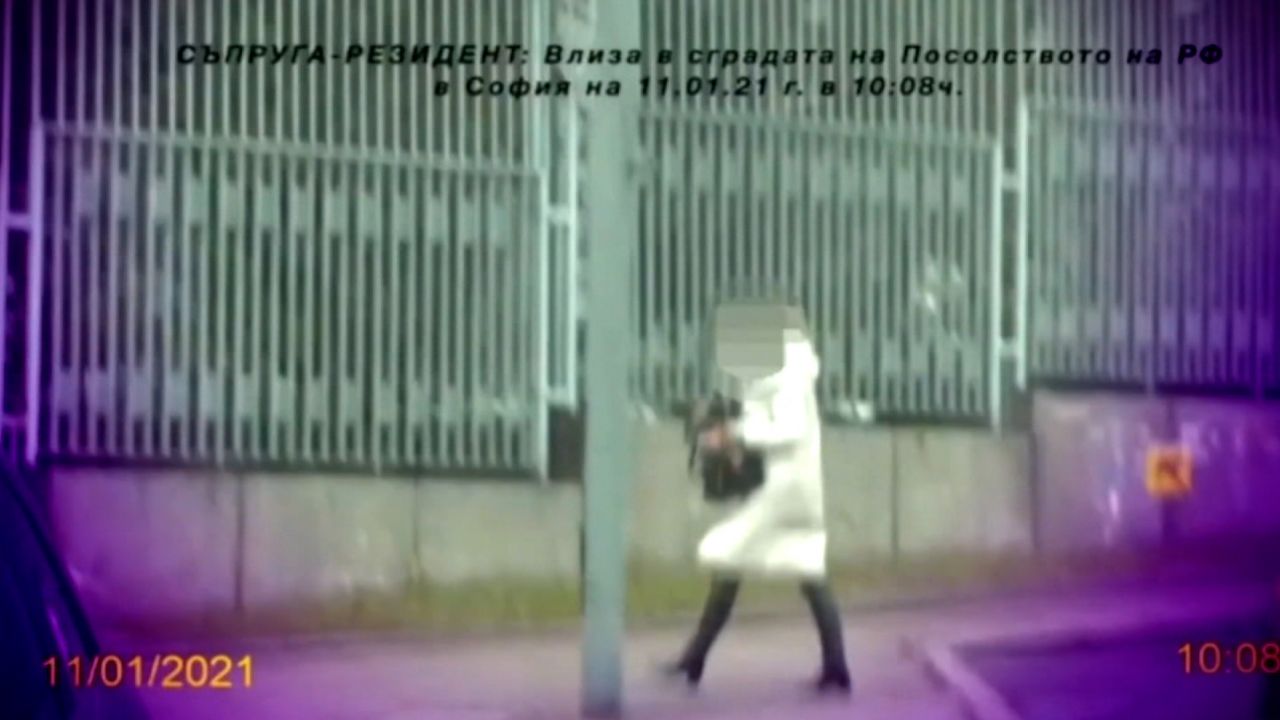 A woman leaves the Russian embassy in the Bulgarian capital, Sofia, with what prosecutors claim is a bag full of cash.