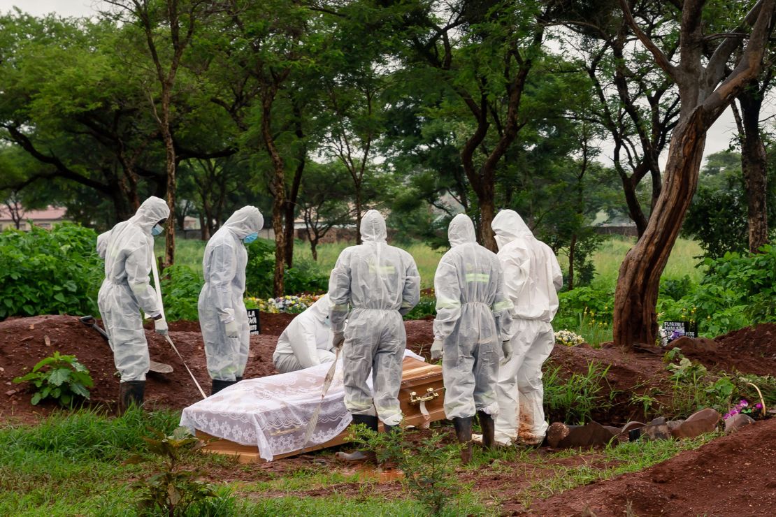 Undertakers lower the coffin of a person who died from Covid-19 at Glen Forest cemetery in Harare, Zimbabwe on January 14, 2021.