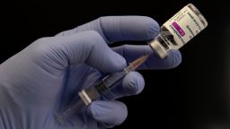 GERMANY, BONN - MARCH 23: This photo illustration shows a AstraZeneca vaccine vial and a medical syringe in a hand with a blue latex glove, on March 23, 2021 in Bonn, Germany.  (Photo by Ulrich Baumgarten via Getty Images)