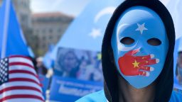 A demonstrator, wearing a mask, takes part in a protest against Chinas human rights abuses against Uighur Muslims in Xinjiang province, calling on U.S. government to take action against Beijing, on April 06, 2019 in Washington, United States. (Photo by Yasin Ozturk/Anadolu Agency/Getty Images)