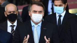 Brazilian President Jair Bolsonaro makes a statement to the press after meeting with the heads of the three government branches and their ministers to discuss possible solutions for the COVID-19 pandemic crisis that is plaguing the country, at the Alvorada Palace in Brasilia, on March 24, 2021, - Brazil's daily Covid-19 death toll soared past 3,000 for the first time on the eve, as the hard-hit country struggled to contain a surge of cases that has pushed many hospitals to breaking point.
