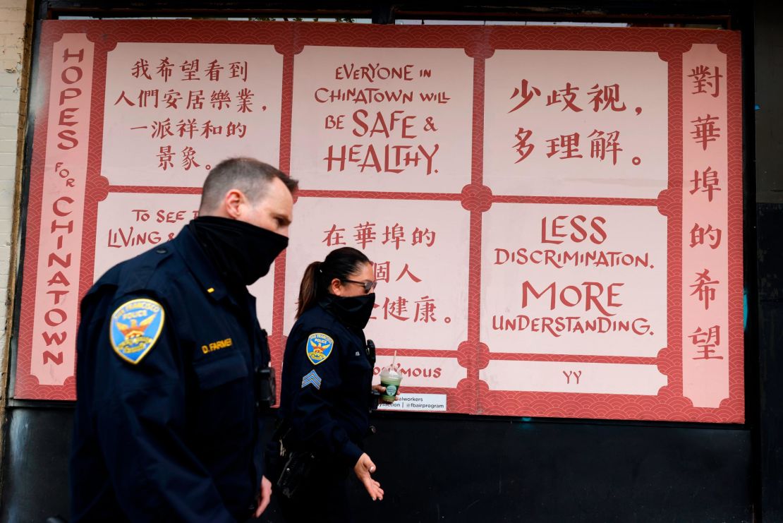 San Francisco police officers pass an art installation called "Hopes for Chinatown."