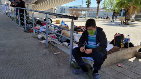 Deported migrants gathered under a bridge at the border, but were later ordered to leave by authorities.