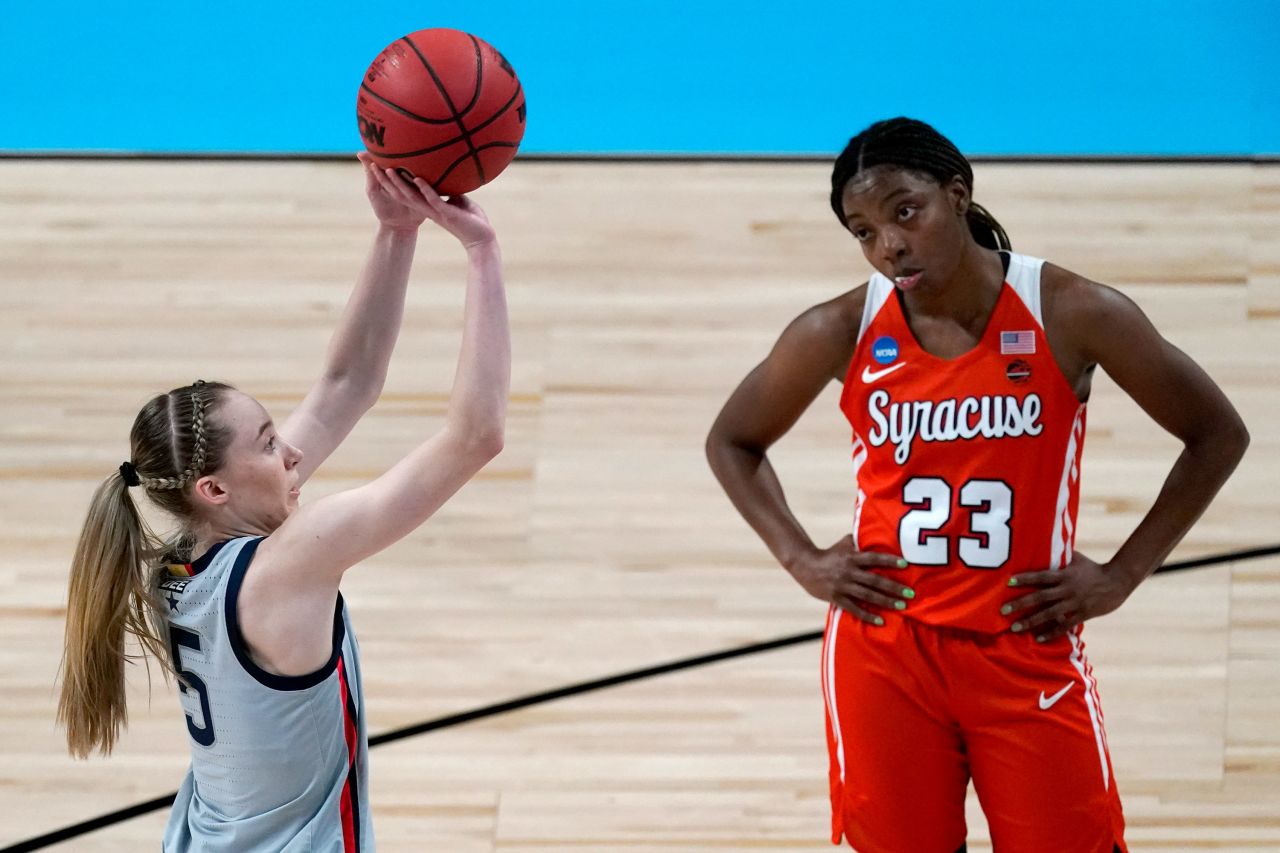 Syracuse guard Kiara Lewis watches as Connecticut's Paige Bueckers shoots a free throw on March 23. Bueckers, a freshman, is a first-team All-American.