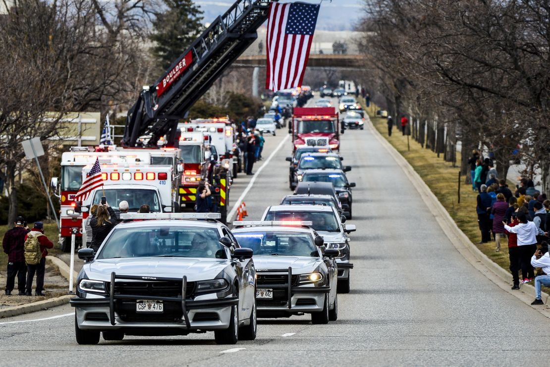Law enforcement vehicles escort the body of slain Boulder Police Officer Eric Talley to a funeral home Wednesday.