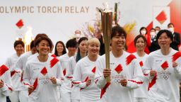 Tokyo 2020 Olympic Torch Relay Grand Start torchbearers from Japan's women's national soccer team, or Nadeshiko Japan, lead the torch relay in Naraha, Fukushima prefecture on March 25, 2021. (Photo by KIM KYUNG-HOON / POOL / AFP) (Photo by KIM KYUNG-HOON/POOL/AFP via Getty Images)