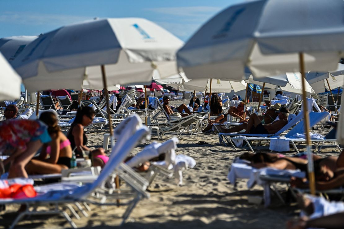 People relax on the beach in Miami Beach, Florida, on March 23, 2021