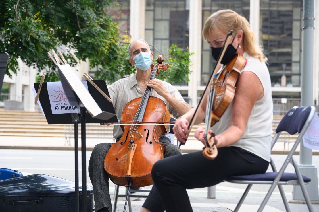 Principal Cello Carter Brey, and Principal Viola Cynthia Phelps of the New York Philharmonic perform a surprise free show outside Lincoln Center on July 7, 2020 in New York City. (Photo by Noam Galai/Getty Images)