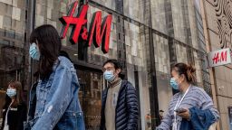 People walk past a store of Swedish clothing giant H&M in Beijing on March 25, 2021. (Photo by NICOLAS ASFOURI / AFP) (Photo by NICOLAS ASFOURI/AFP via Getty Images)