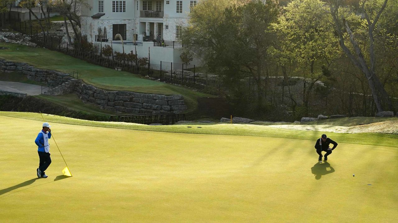 McIlroy lines up a putt on the fourth green in his match against Poulter.