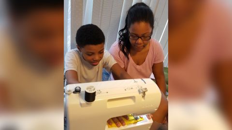 Darius Brown making a bow tie with his older sister, Dazhai Brown.