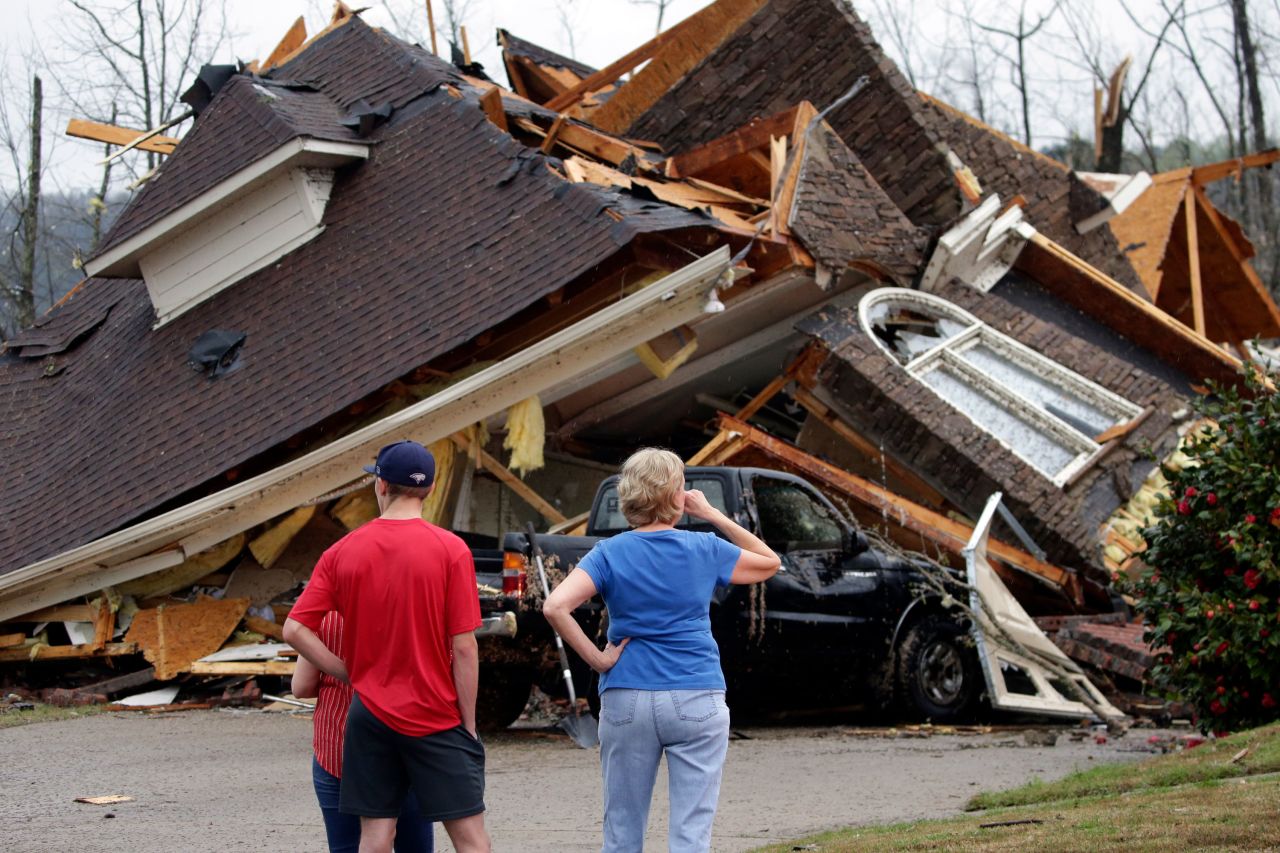 Residents survey damage to homes in the Eagle Point neighborhood south of Birmingham on Thursday.