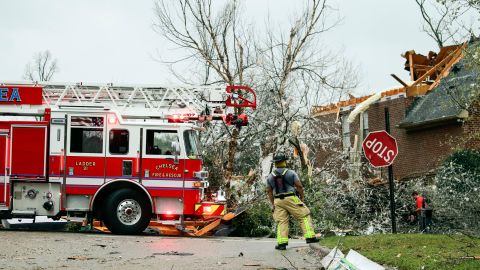 A firefighter surveys damage after a tornado touched down in the Eagle Point community near Birmingham. Alabama. 