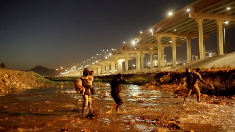 Migrants cross the Rio Bravo river  as seen from Ciudad Juarez, Mexico, to turn themselves in to US Border Patrol agents to request asylum on March 19, 2021, in El Paso, Texas.