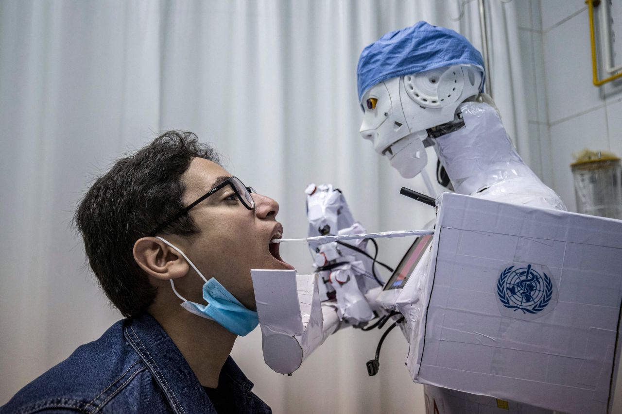 A remote-controlled robot takes a throat swab at a hospital in Tanta, Egypt, on March 20. The robot prototype is part of a project to assist physicians in testing patients for Covid-19.