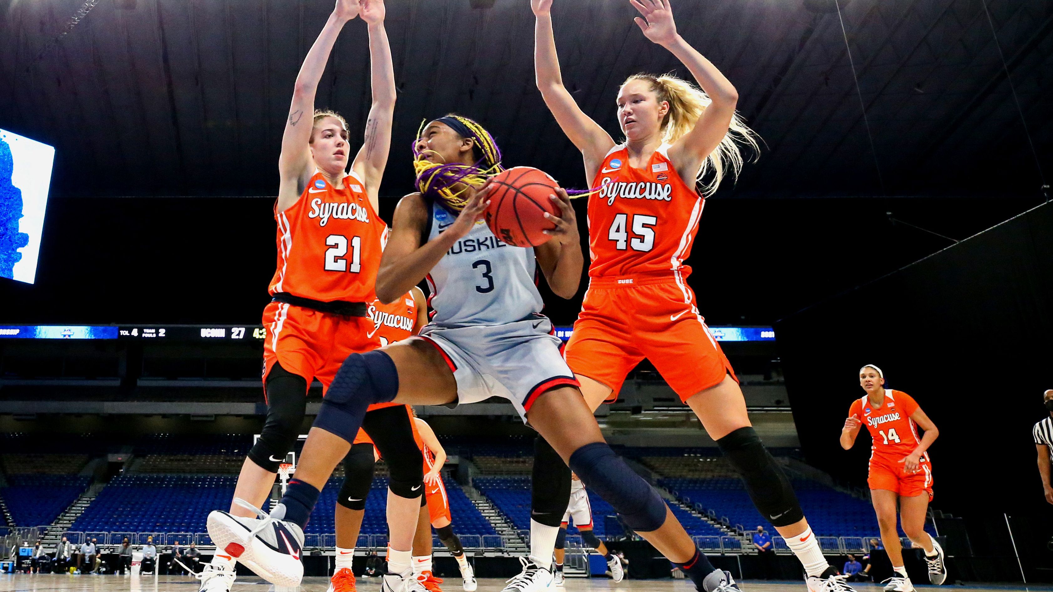 Aaliyah Edwards #3 of the UConn Huskies looks to pass against Emily Engstler #21 and Digna Strautmane #45 of the Syracuse Orange during the first half in the second round game of the 2021 NCAA Women's Basketball Tournament