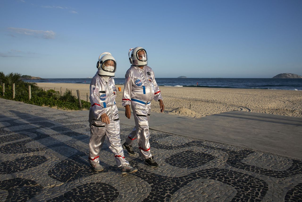 Tercio Galdino and his wife, Alicea, wear astronaut costumes to protect themselves from Covid-19 as they walk along the Ipanema Beach in Rio de Janeiro on March 20.