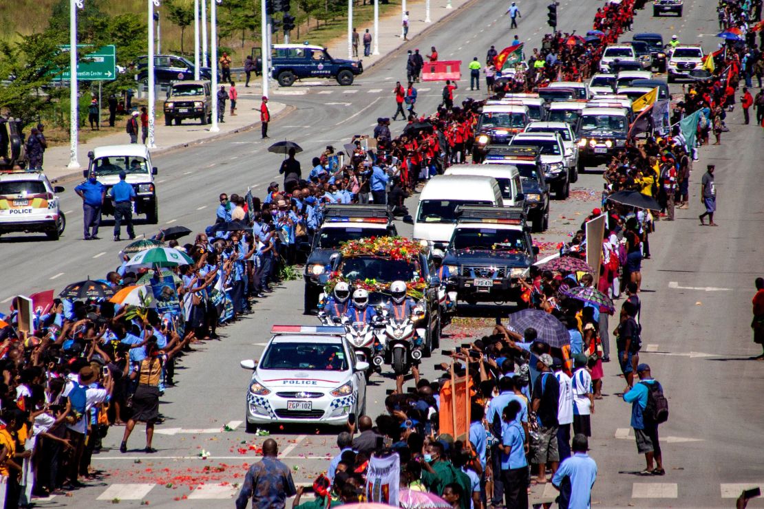 People line up as police escort a hearse carring the coffin of Papua New Guinea's first Prime Minister Michael Somare in Port Moresby on March 11.