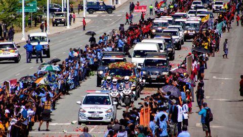 People line up as police escort a hearse carring the coffin of Papua New Guinea's first Prime Minister Michael Somare in Port Moresby on March 11.