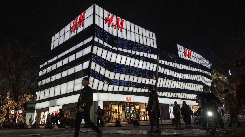 BEIJING, CHINA - MARCH 25: People walk by the flagship store of clothing brand H&M at a shopping area on March 25, 2021 in Beijing, China. Many on Chinese social networking platforms called for boycotts of major Western brands, including H&M, after statements made by the companies in the past about Xinjiang cotton resurfaced online. (Photo by Kevin Frayer/Getty Images)