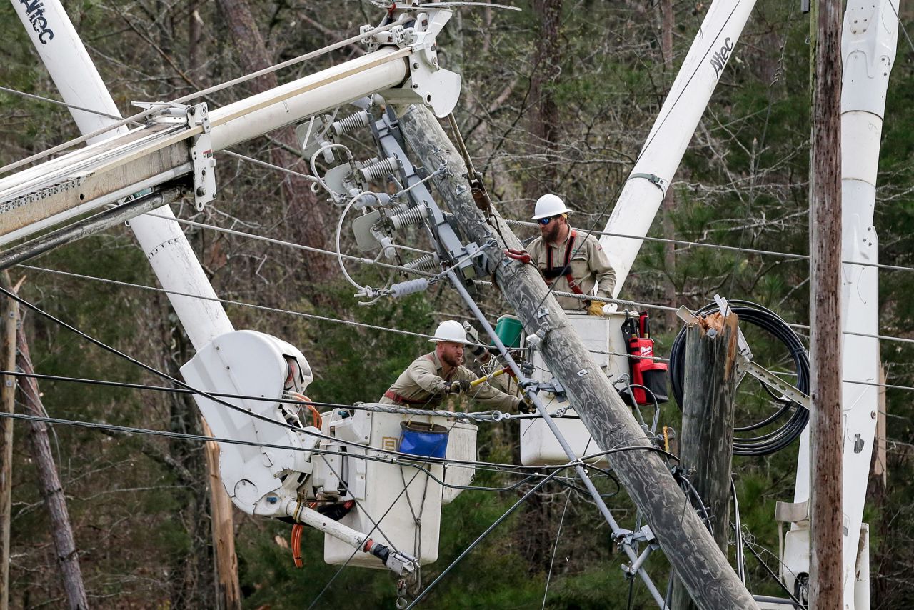 Crews work to restore power in Wellington, Alabama, on Friday. About 38,000 homes and businesses were without power in Alabama and Georgia on Friday morning, according to utility tracker PowerOutage.us.