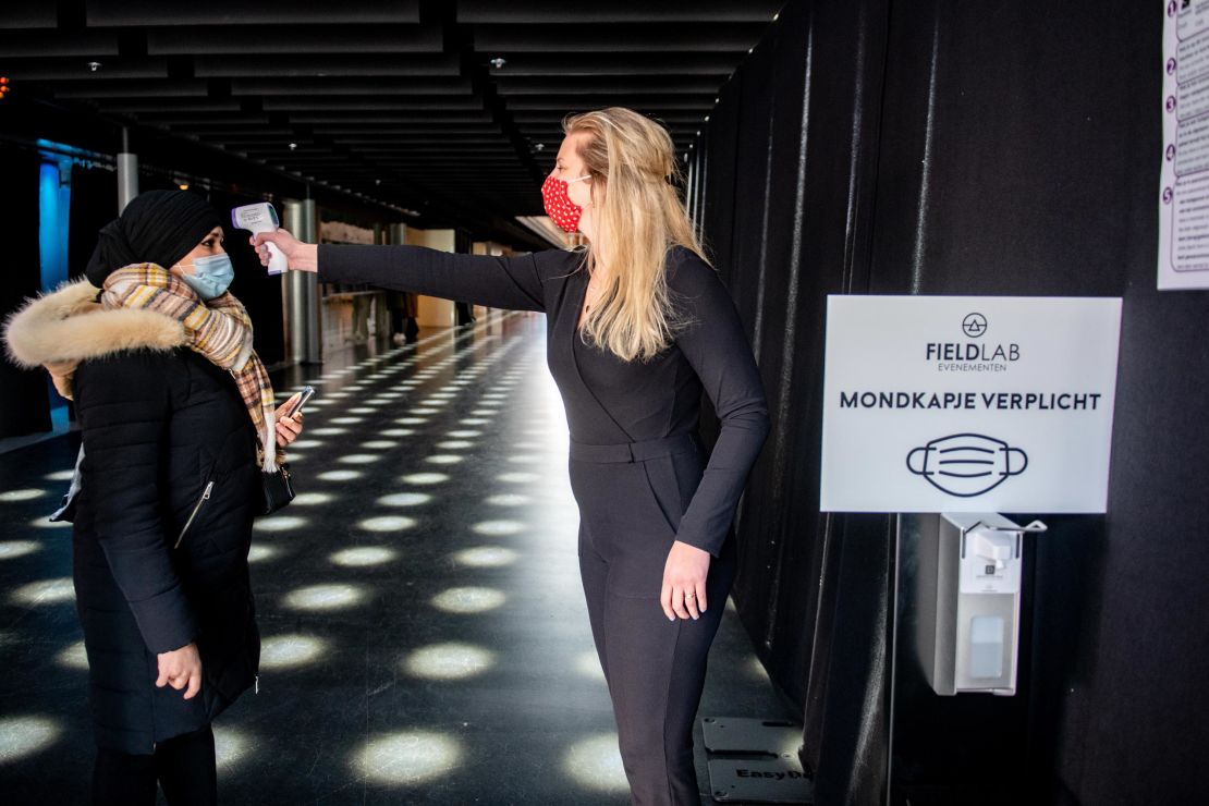 A visitor has their temperature measured before entering The Ziggo Dome in Amsterdam on March 6 2021.