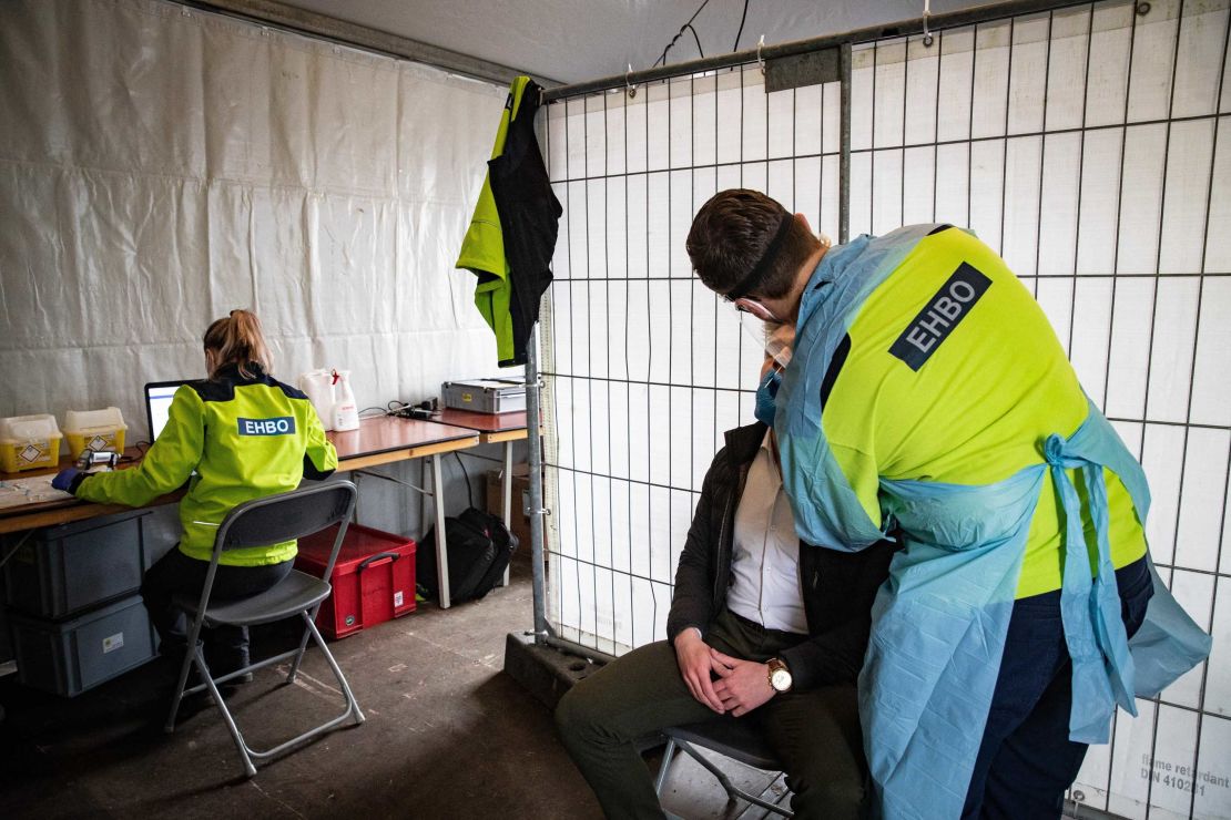 A visitor is tested for Covid-19 during random tests at the entrance of the "Back To Live" pop festival.