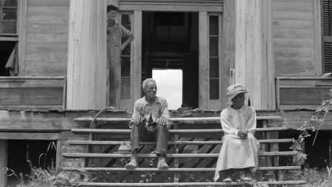 An ex-slave and his wife on the steps of a decaying plantation house in  Greene County, Georgia. Many Black Southerners saw their rights gradually eroded in the late 1800s.