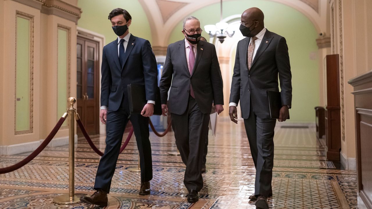 Senate Majority Leader Chuck Schumer, D-N.Y., center, is joined by Sen. Jon Ossoff, D-Ga., left, and Sen. Raphael Warnock, D-Ga., for a news conference to discuss the COVID relief bill, at the Capitol in Washington in February.