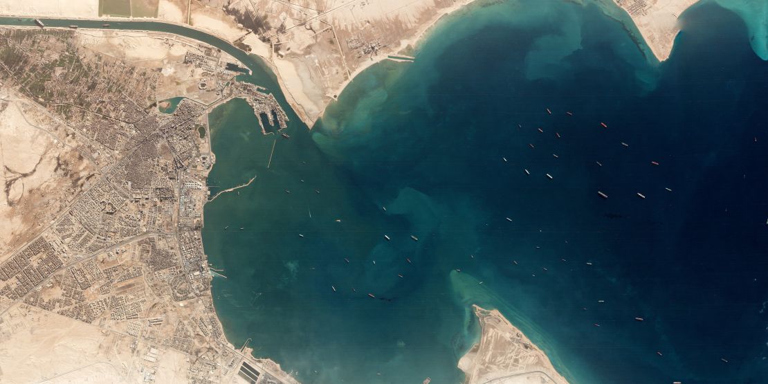 A satellite image shows the Ever Given and idling ships at the entrance of the Suez Canal.