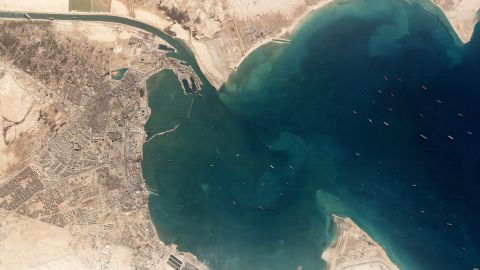 A satellite image shows the Ever Given and idling ships at the entrance of the Suez Canal. 