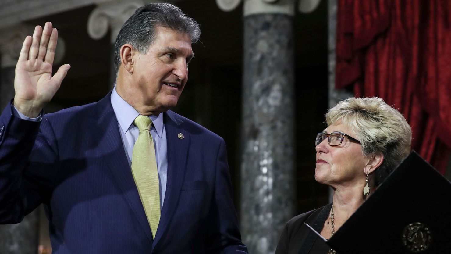 Sen. Joe Manchin is flanked his wife, Gayle Manchin, as he is sworn in on January 3, 2019.