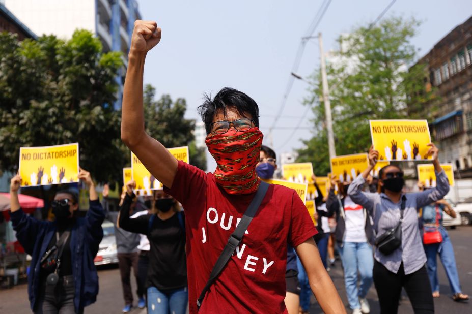 Protesters gesture during a march in Yangon on March 26.