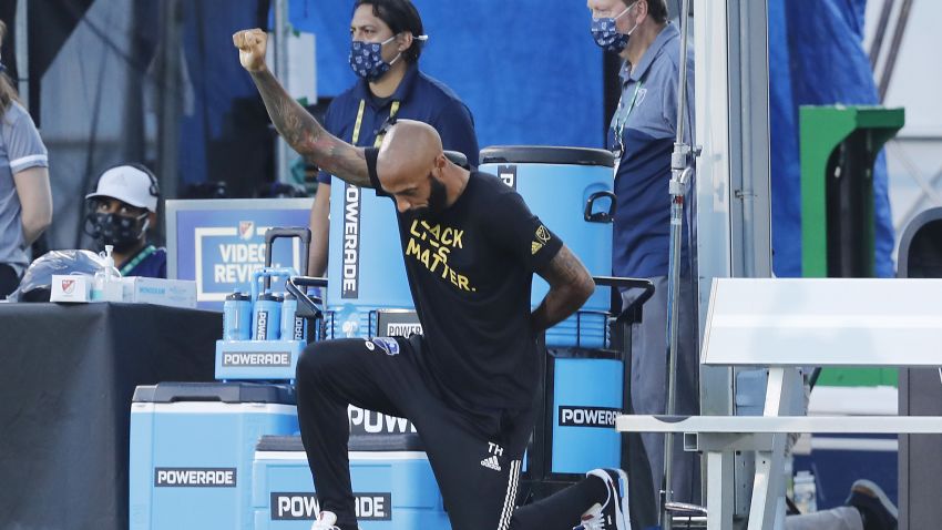 REUNION, FLORIDA - JULY 16: Head coach Thierry Henry of Montreal Impact takes a knee in support of the Black Lives Matter movement prior to a Group C match against Toronto FC as part of the MLS Is Back Tournament at ESPN Wide World of Sports Complex on July 16, 2020 in Reunion, Florida. (Photo by Michael Reaves/Getty Images)